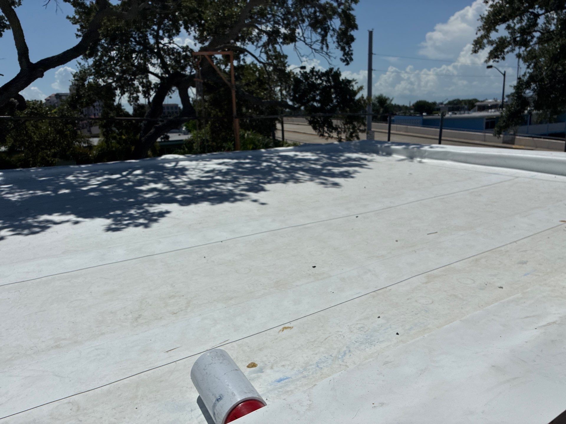Completed white TPO membrane roof with parapet wall