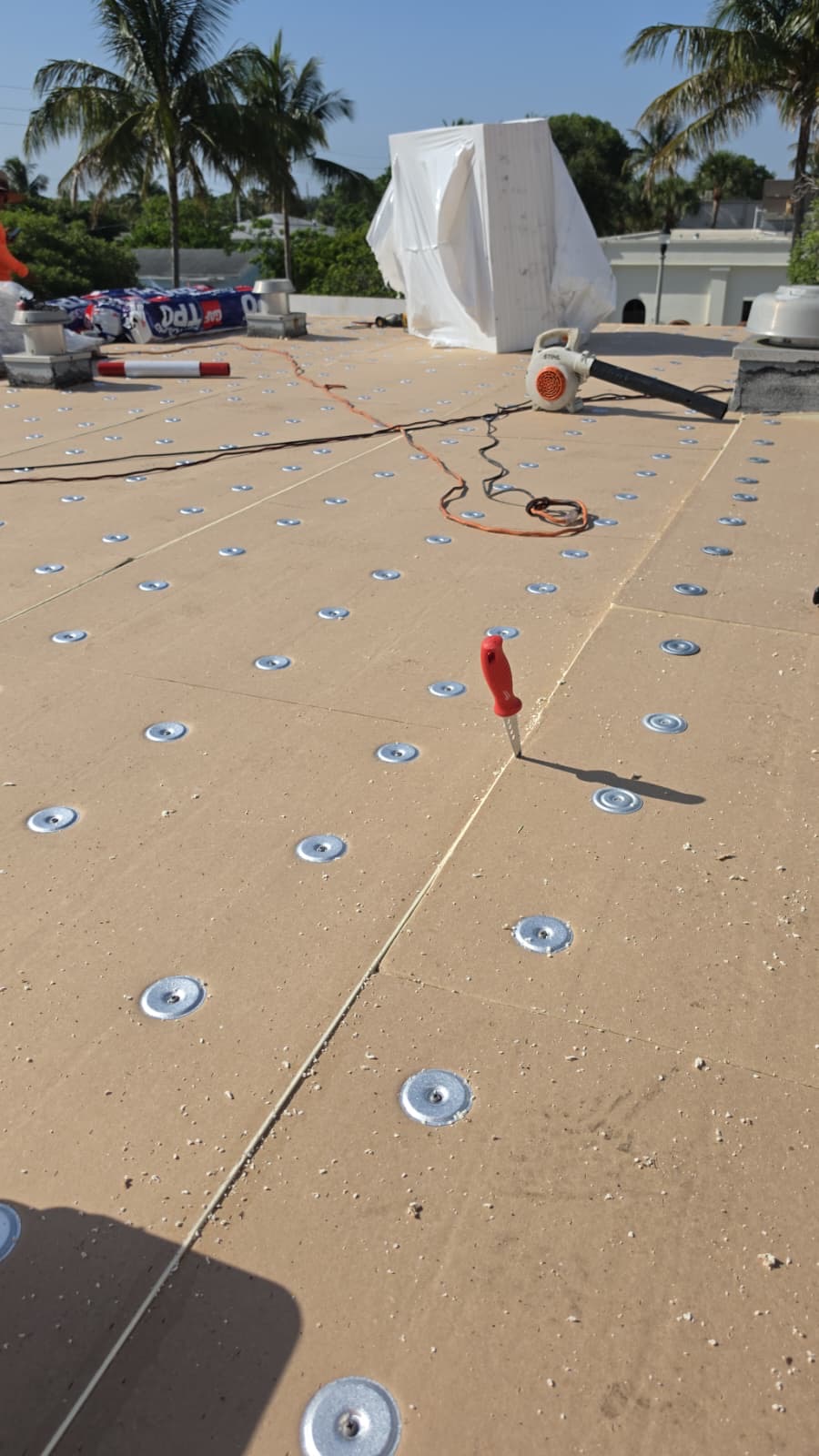 Fastened insulation boards ready for membrane on a flat roof