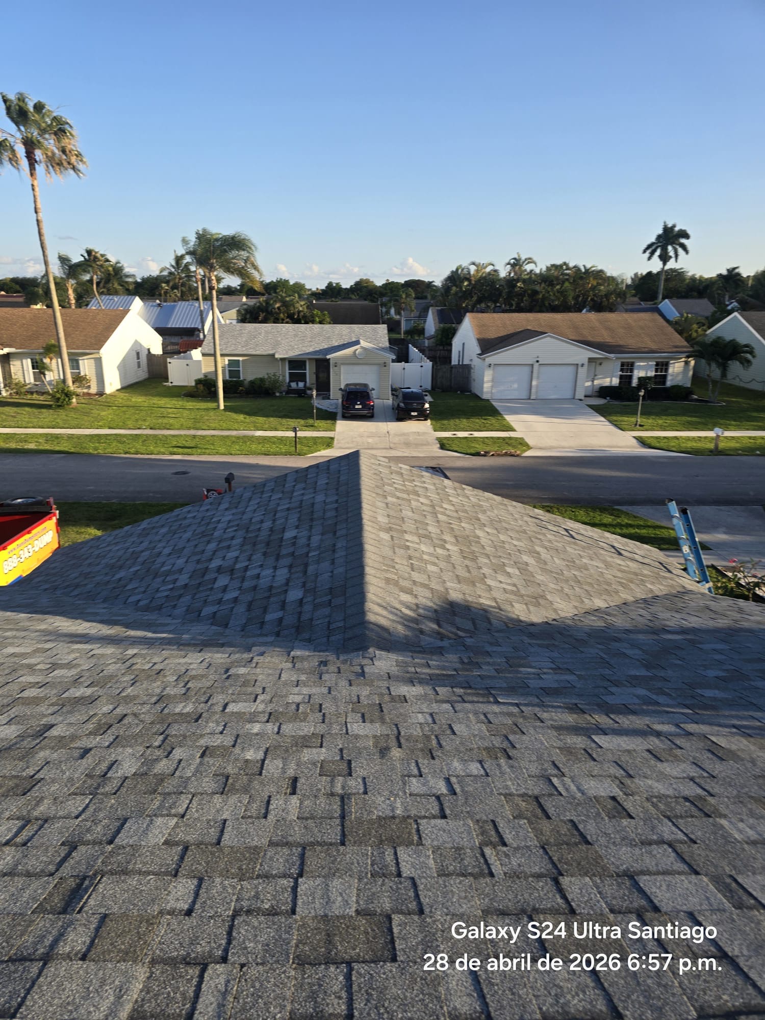 Completed hip shingle roof with neighborhood view