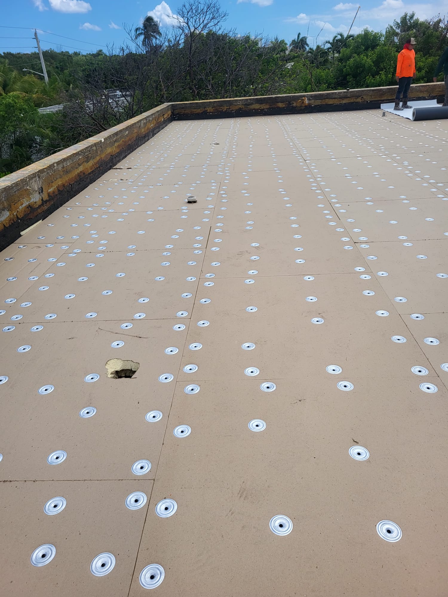 Insulation board fastened with plates before TPO membrane install